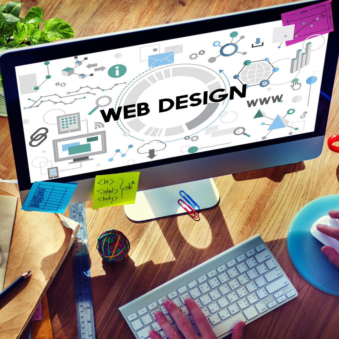 Professional web design workspace featuring a designer planning website layouts, UI/UX elements, and digital marketing graphics on a modern desktop computer.